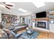 Elegant living room with a fireplace, built-in shelving, a flat-screen TV, and comfortable seating at 4002 Joshua Ln, Douglasville, GA 30135