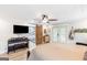 Bright main bedroom featuring wood floors, a ceiling fan, and barn-door access to ensuite at 4002 Joshua Ln, Douglasville, GA 30135