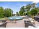 Backyard pool featuring a seating area with cozy chairs and a side table set on a wooden deck at 4002 Joshua Ln, Douglasville, GA 30135