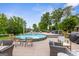 Backyard pool featuring a seating area with cozy chairs and a side table set on a wooden deck at 4002 Joshua Ln, Douglasville, GA 30135