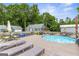 Backyard pool and patio area featuring lounge chairs and outdoor seating, perfect for relaxation and entertaining at 4002 Joshua Ln, Douglasville, GA 30135