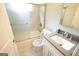 Bright bathroom with white vanity, gray countertop, and a shower-tub combo with glass doors at 3010 Waters Rd Sw, Atlanta, GA 30354