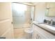 Bright bathroom with white vanity, gray countertop, and a shower-tub combo with glass doors at 3010 Waters Rd Sw, Atlanta, GA 30354