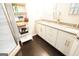 Bathroom featuring double vanity, storage shelving, and glass-enclosed shower at 3010 Waters Rd Sw, Atlanta, GA 30354