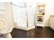 View of the bathroom featuring a large shower with a built in seat and wood floors at 3010 Waters Rd Sw, Atlanta, GA 30354
