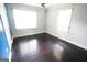 Spacious bedroom features hardwood floors, a ceiling fan, and natural light from two windows at 3010 Waters Rd Sw, Atlanta, GA 30354