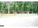 Charming single-story brick home with mature trees and a rustic wooden fence at 3010 Waters Rd Sw, Atlanta, GA 30354