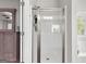 Bathroom featuring a glass shower, and a glimpse of a soaking tub at 140 Canyons, Hampton, GA 30228