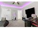 A modern bedroom showcasing sleek LED lighting and a dedicated gaming and workspace at 140 Canyons, Hampton, GA 30228