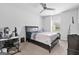 A spacious bedroom featuring a dark wood bed frame and a well-lit workspace at 140 Canyons, Hampton, GA 30228