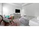 This bedroom boasts a leather couch, dresser with TV, and a cozy bed at 140 Canyons, Hampton, GA 30228