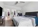 A spacious bedroom with a large bed and an adjacent workspace featuring LED lighting at 140 Canyons, Hampton, GA 30228