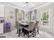 Bright dining area featuring modern lighting, stylish decor, and a convenient wine cooler at 140 Canyons, Hampton, GA 30228