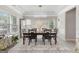 Bright dining room with stylish chandelier, large windows, and seating for six at 140 Canyons, Hampton, GA 30228