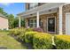 Inviting front porch with stone accents, lush landscaping, and a welcoming front door at 140 Canyons, Hampton, GA 30228