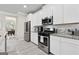 Well-equipped kitchen with stainless steel appliances, granite countertops, and ample cabinet space at 140 Canyons, Hampton, GA 30228