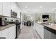 Open-concept kitchen featuring granite countertops, stainless steel appliances, and an adjacent dining area at 140 Canyons, Hampton, GA 30228