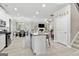 Open-concept living space featuring a kitchen island, dining area, and cozy living room with a fireplace at 140 Canyons, Hampton, GA 30228