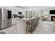 Modern kitchen featuring stainless steel appliances, a granite countertop island, and barstool seating at 140 Canyons, Hampton, GA 30228