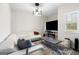 Cozy living room featuring a sleek white sofa, modern lighting, and fireplace at 140 Canyons, Hampton, GA 30228