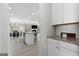 Open concept living space, seamlessly connecting the kitchen, dining, and living areas at 140 Canyons, Hampton, GA 30228