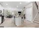 Open-concept living space featuring a kitchen island, dining area, and cozy living room with a fireplace at 140 Canyons, Hampton, GA 30228