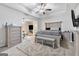 Spacious main bedroom with trey ceiling, TV, and stylish furnishings with sitting area at 140 Canyons, Hampton, GA 30228