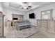 Spacious main bedroom with trey ceiling, TV, and stylish furnishings with a large rug at 140 Canyons, Hampton, GA 30228