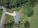 An aerial view of a home with a long driveway, lush landscaping, and a well-maintained lawn at 410 Golf View Dr, Peachtree City, GA 30269