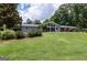 A home with a large backyard, beautiful landscaping, and a spacious patio for outdoor living at 410 Golf View Dr, Peachtree City, GA 30269
