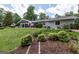A well-manicured backyard with lush landscaping, a patio, and golf course views at 410 Golf View Dr, Peachtree City, GA 30269