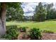 A peaceful backyard oasis featuring mature trees, landscaping and golf course views at 410 Golf View Dr, Peachtree City, GA 30269