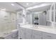 Bathroom features a shower, vanity with double sinks, large mirror, and a neutral color scheme at 410 Golf View Dr, Peachtree City, GA 30269
