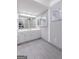 Spacious bathroom with a white vanity, large mirror, tile flooring, and natural light at 410 Golf View Dr, Peachtree City, GA 30269