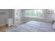 Bedroom with ensuite bathroom, wood floors, neutral walls, and a large window at 410 Golf View Dr, Peachtree City, GA 30269