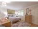 Cozy bedroom featuring colorful wallpaper, wood floors, and a comfortable bed with stylish decor at 410 Golf View Dr, Peachtree City, GA 30269