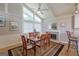 Elegant dining room with fireplace, large windows, and stylish furnishings at 410 Golf View Dr, Peachtree City, GA 30269