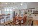 Dining room with adjacent kitchen and custom built-in cabinets and display shelving at 410 Golf View Dr, Peachtree City, GA 30269