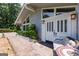 Close-up of the beautiful white double front doors with decorative glass, and cozy outdoor seating area at 410 Golf View Dr, Peachtree City, GA 30269