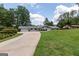 A well-maintained home with a long driveway, manicured lawn, and beautiful landscaping at 410 Golf View Dr, Peachtree City, GA 30269