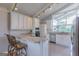 Updated kitchen with granite countertops, bar seating, stainless appliances, and modern lighting fixtures at 410 Golf View Dr, Peachtree City, GA 30269