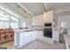 Well-equipped kitchen with granite countertops, stainless appliances, and adjacent dining area at 410 Golf View Dr, Peachtree City, GA 30269