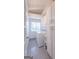 Well-lit laundry room with sleek gray tile floors, white cabinets, and modern washer and dryer set at 410 Golf View Dr, Peachtree City, GA 30269