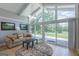 Bright living room featuring vaulted ceilings and large windows with sliding glass door at 410 Golf View Dr, Peachtree City, GA 30269