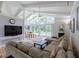 Bright living room with vaulted ceilings, ceiling fan, and large windows overlooking the backyard at 410 Golf View Dr, Peachtree City, GA 30269