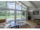 Bright living room with vaulted ceilings and sliding glass doors opening to a golf course view at 410 Golf View Dr, Peachtree City, GA 30269