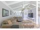 Bright living room with vaulted ceilings, ceiling fan, and large windows overlooking the backyard at 410 Golf View Dr, Peachtree City, GA 30269