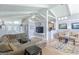 Bright living room with vaulted ceilings, ceiling fan, and large windows overlooking the backyard at 410 Golf View Dr, Peachtree City, GA 30269