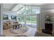 Bright living room featuring vaulted ceilings and large windows with sliding glass door at 410 Golf View Dr, Peachtree City, GA 30269