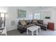 Relaxing living room with plush seating, white walls, and minimalist decor, ideal for a comfortable home at 410 Golf View Dr, Peachtree City, GA 30269